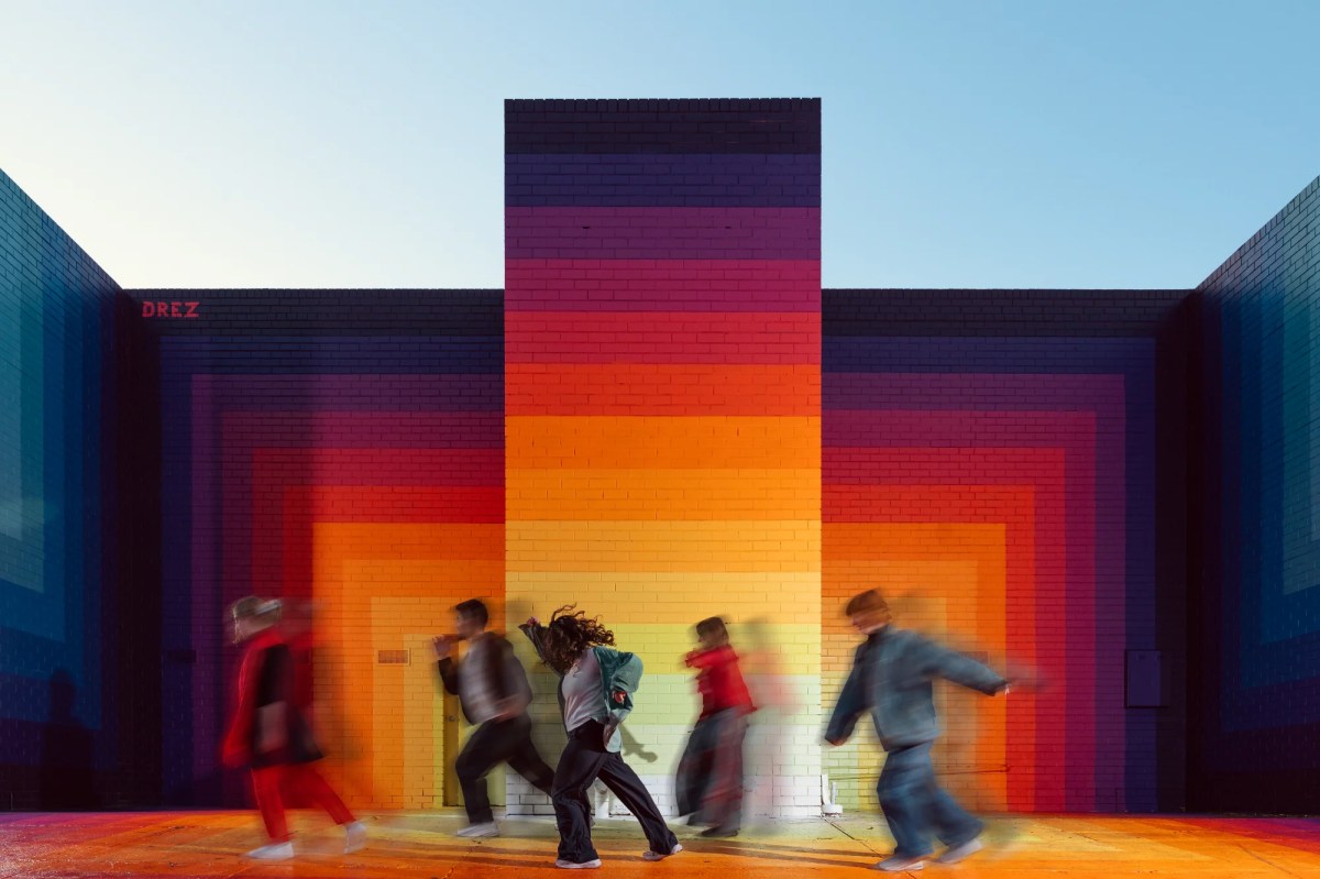 Quiet Riot's 'Power Move', the Civic Commission at the 2025 Melbourne Fringe. The image shows five young people, blurred my movement as they dance inside a colourful, monolithic art installation at Melbourne Fringe Festival.