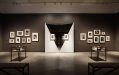 Small black and white photographers arranged in two clusters on either side of two mirrors, each with a small photographer in the centre. Man Ray and Max Dupain at Heide.