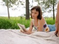 A young woman lying on a blanket outside reading a book. Prime Minister’s Literary Awards.