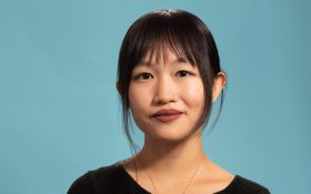 A young Asian woman with her hair in a pony tail. R F Kuang, author of Katabasis.
