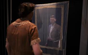 A woman is looking at a man through a veiled frame in Three Plays.