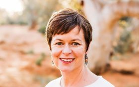A woman with short brown hair and a white top. Wenona Byrne. Writing Australia