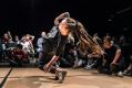 A dynamic photograph of a b-girl breaking, illustrating ArtsHub's weekly On the Move, column, which summarises recent arts sector appointments from across Australia.