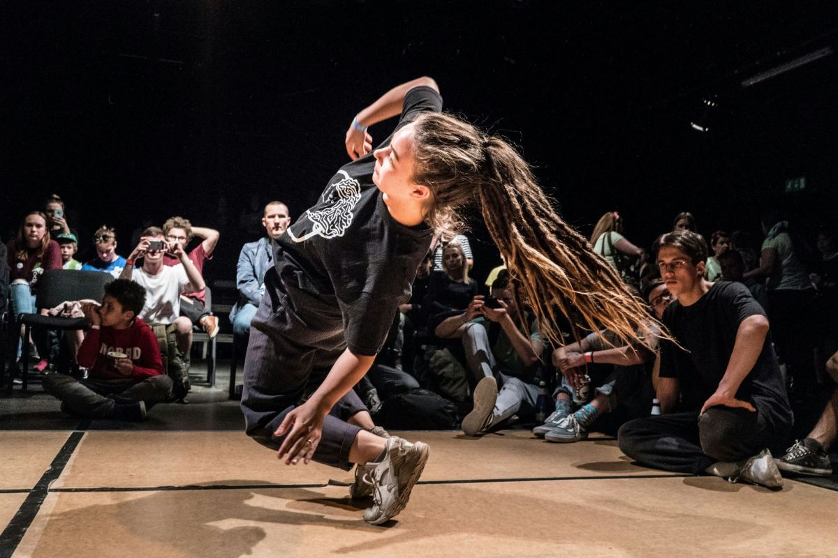 A dynamic photograph of a b-girl breaking, illustrating ArtsHub's weekly On the Move, column, which summarises recent arts sector appointments from across Australia.