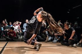 A dynamic photograph of a b-girl breaking, illustrating ArtsHub's weekly On the Move, column, which summarises recent arts sector appointments from across Australia.