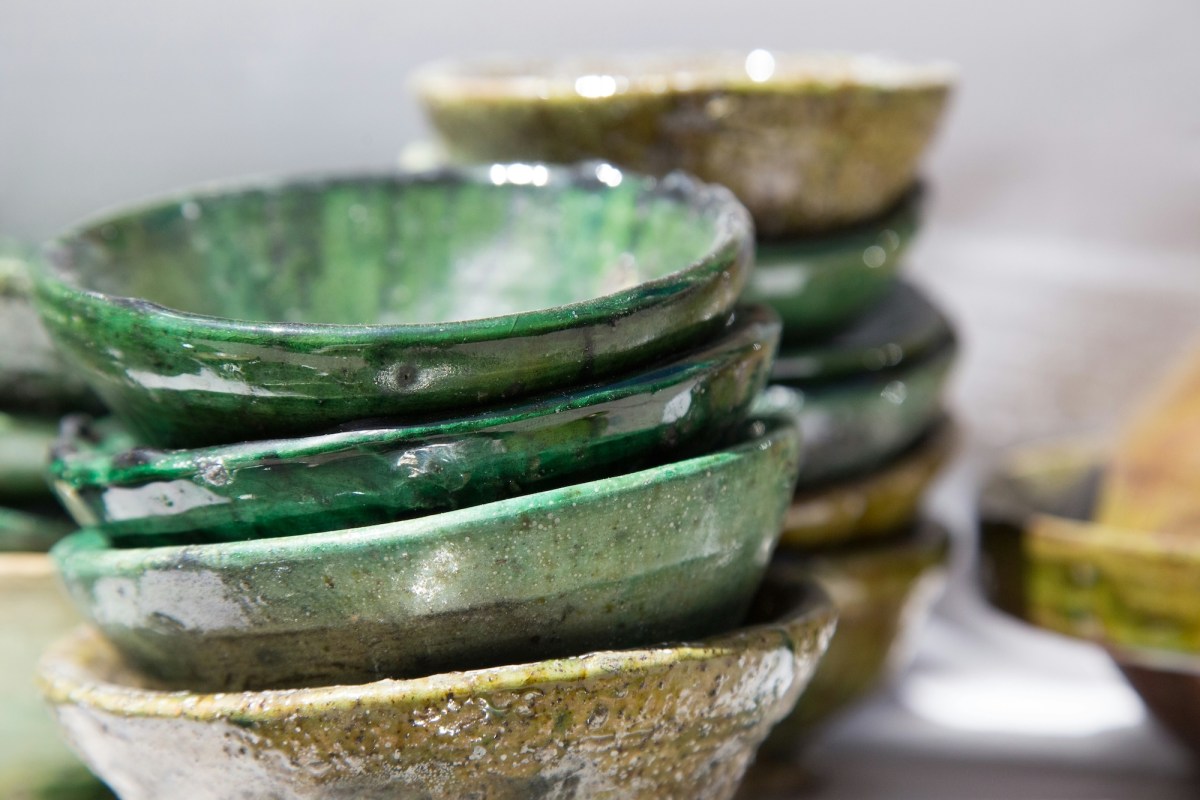 Stack of hand made bowls with a green glaze. Silicosis