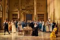 The cast of The Marriage of Figaro in costume in a large hall.