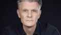 Rhett Davis, a profile photo of a man with short grey hair. Author of Arborescence.