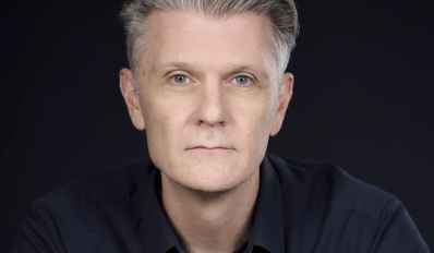 Rhett Davis, a profile photo of a man with short grey hair. Author of Arborescence.
