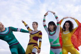 Dancenorth archival costumes from the 1990 production 'Desert Magic'. L-R: Michael Smith, Sabine Crompton-Ward, Tiana Lung and Marlo Benjamin. Four dancers pose playfully in brightly coloured, abstract, skin-tight costumes from four decades ago.