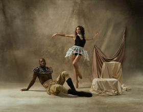Juan Carlos Osma, a Black man sitting on the floor, and Alexa Tuzil, a fair-skinned woman standing with arms outstretched and one leg raised, in a promotional image for West Australian Ballet's 2026 season.