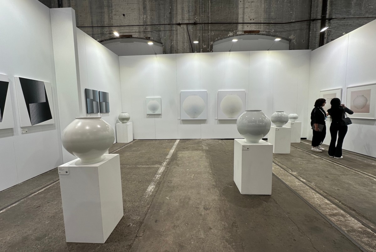 view of an art fair displaying porcelain moon shaped vases. Sydney Contemporary