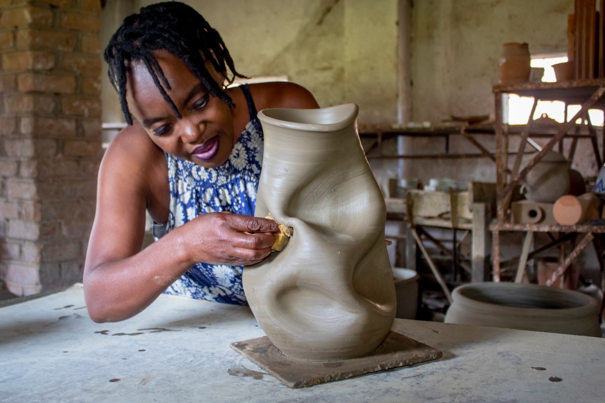African ceramicist working on an organic formed pot. Homo Faber