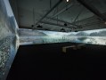 Gallery view of an expansive video of ocean and coastline across three walls. Lisa Reihana