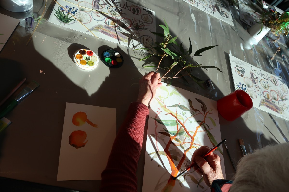 detail of a person painting a tree and leaves in a workshop. Analog Art Club