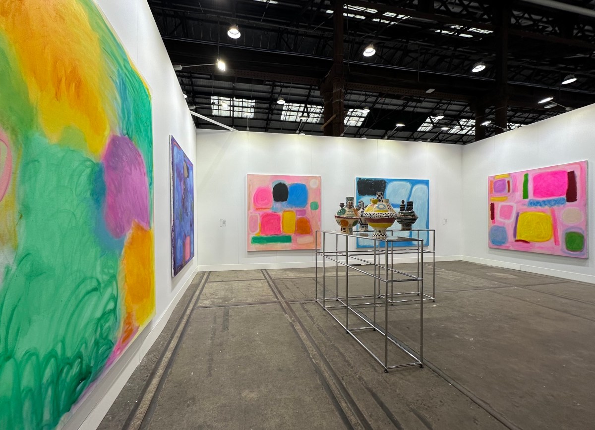 Brightly color abstract paintings and ceramic pots in an art fair setting. Sydney Contemporary.