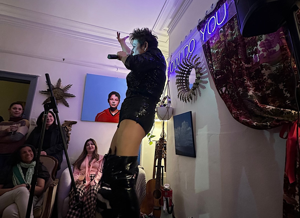 Woman performing cabaret act in living room. House concerts