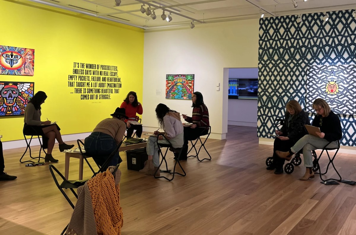 Group of people in a gallery setting drawing. Analog Art Club