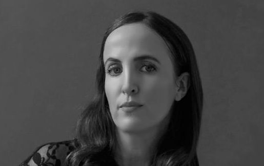 A black and white photo of a woman with dark hair. Emma Sloley, author of The Island of Last Things.