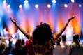 woman at concert on audience with arms raised. AusArt Day