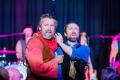 L-R: James Pender as Burke and Sammy J as Wills in a scene from 'Fiasco: A Burke & Wills Musical' at Melbourne Fringe. Two fair-skinned, bearded men wearing stylised 19th century costumes clutch each other in a comically exaggerated fashion.