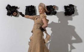 Melbourne fashion week. Photo of a model wearing a garment made out of ute bags posing.