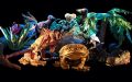 A selection of large animal puppets on a black stage, including cane toad, lizard, koala and birds.