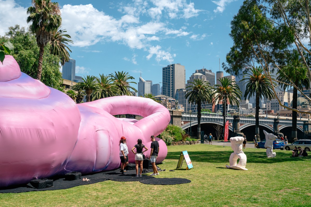 Giant pink inflatable cochlear in a sunny outdoor setting against the Melbourne city landscape. 