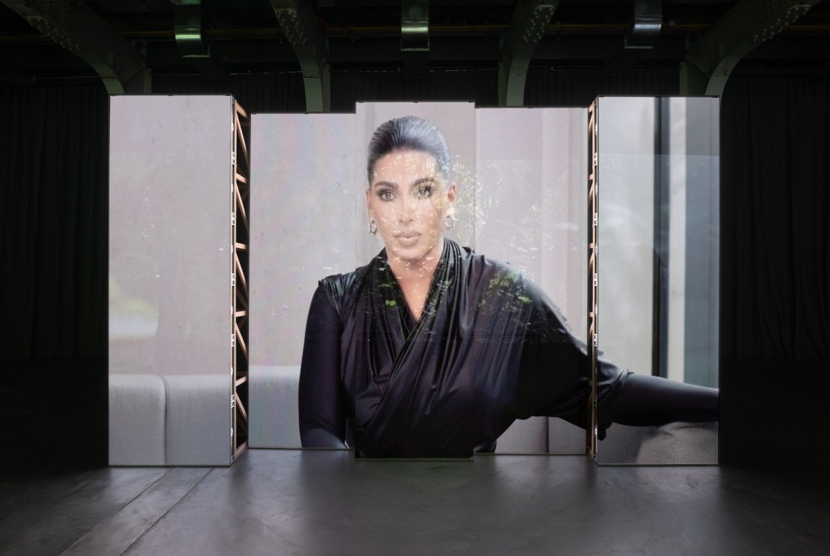 Image of screens in gallery projecting AI generated artist collaborated artwork. AI MCA