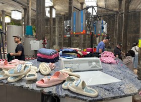 Gallery installation with dryers and recycled slippers in basement environment. Mike Hewson.