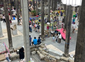Monkey bars with kids playing in a basement gallery space. Mike Hewson
