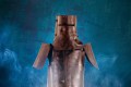 A publicity image for Victorian Opera's upcoming production, a revival of Reg Livermore's 'Ned Kelly - The Musical', to be staged as part of the company.s 2026 season. Ned Kelly's iconic helmet and armour, beaten out of ploughshares, is photographed against a blue background.