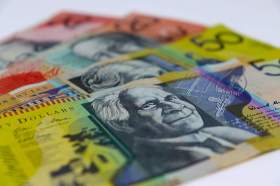 Arts funding: four Australian bank notes laid on a table. Two twenty dollar bills appear at the back covered partially by two fifty dollar note on top.