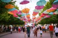Street with colourful umbrellas in festival style. Regional arts programs support communities. Image: Venora Cerium / Unsplash.