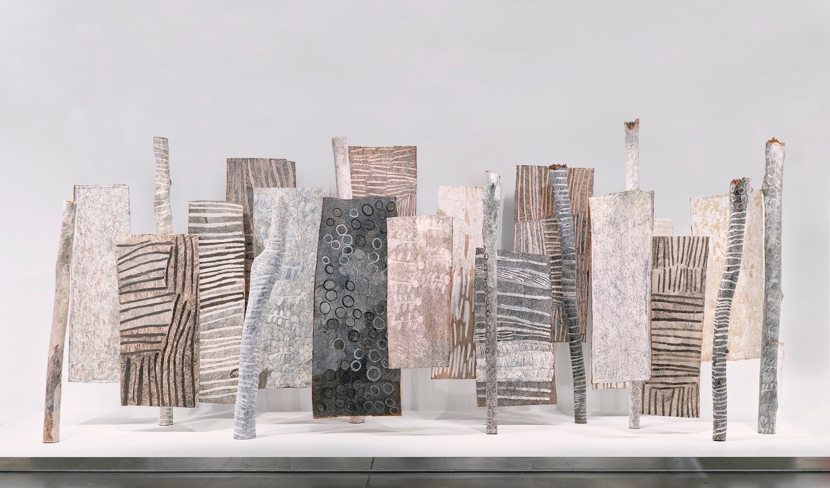 Installation view of painted barks by Aboriginal artist in gallery setting.