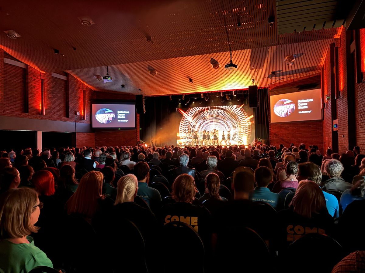 Community members and dignitaries alike gathered for last week’s opening of the new Burnie Arts precinct. The photo is taken at the rear of an auditorium, looking towards the stage over many rows of seated patrons.
