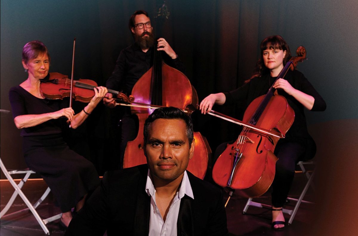 A promotional image for Darwin Symphony Orchestra's 'Shakespeare & Symphony' concert, co-presented with Brown's Mart Theatre in season 2026. The photo shows Darwin-raised Tiwi Islander actor Rob Collins in the foreground; a cellist, a double bass player and a violinist sit behind with their instruments.