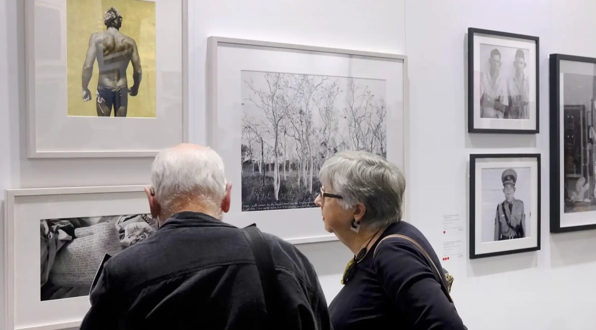 An elderly couple looking at a photography exhibition. Head On Photo Festival.