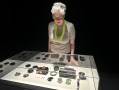 Woman with grey hair looking into museum case with AI technology