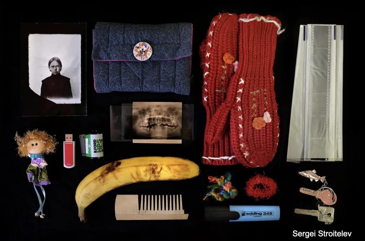 contents from a handbag arranged on black background. Head On Photo Festival