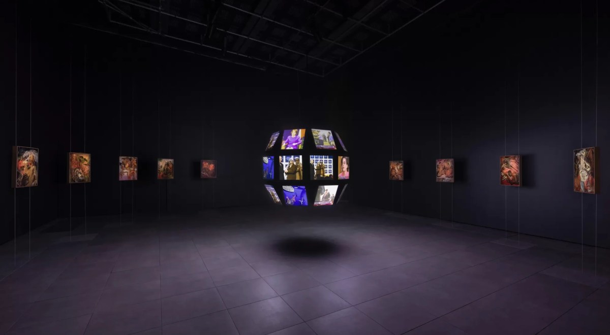 Exhibition gallery view of video work on a floating globe in darkened space. cool exhibitions