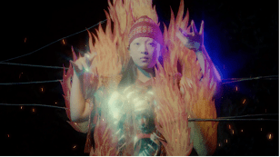 Image of a figure dressed as an asian deity in a film still. MUMA 2026