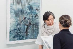 two women talking about an exhibition in a museum. artist