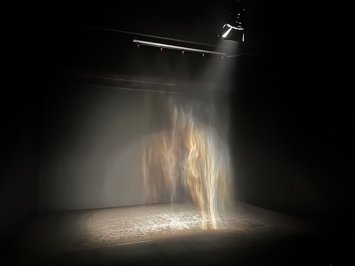 gallery view of an installation with curtain of water and rainbow effect. Olafur Eliasson