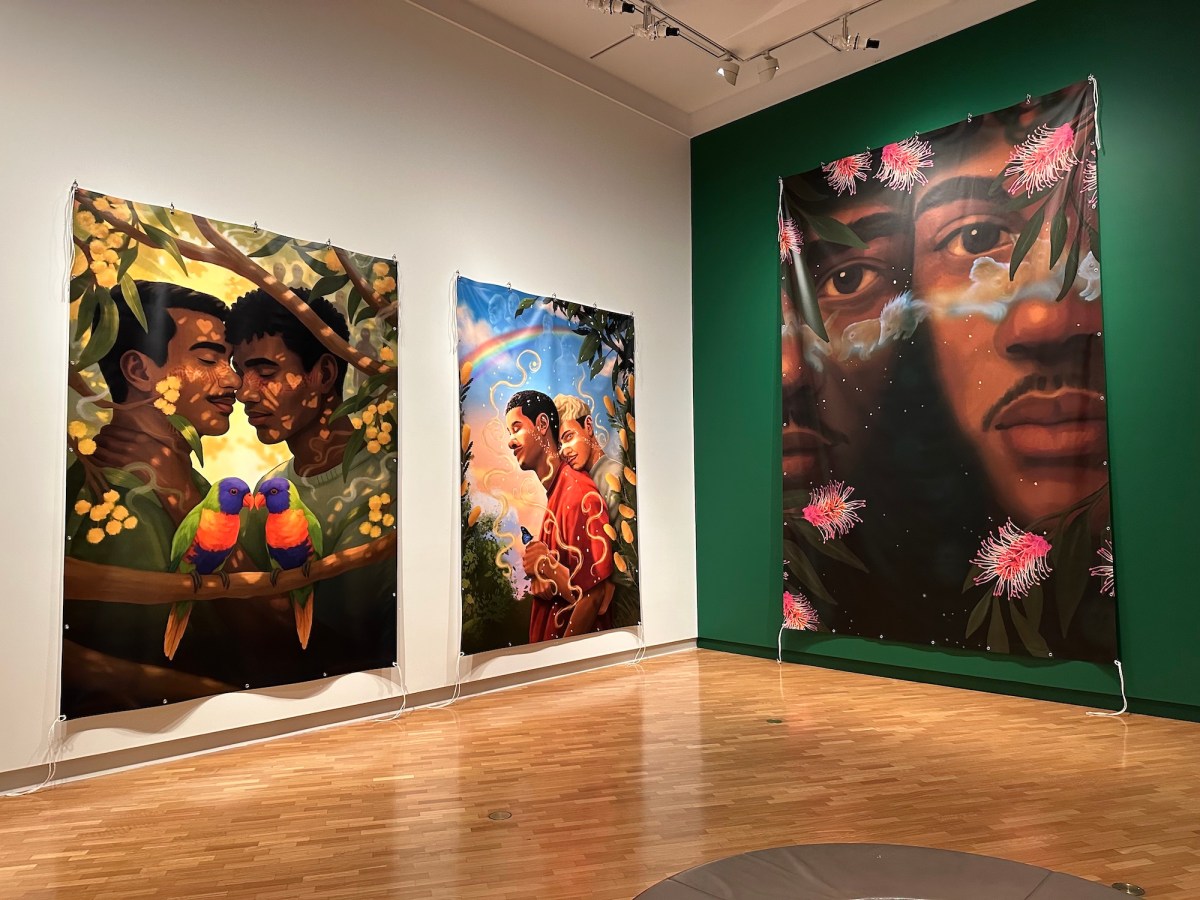 Gallery view of large banner art with intimate male relations. Tony Albert's Indigenous Triennial