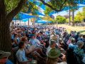 Adelaide Writers' Week at the 2025 Adelaide Festival. Audiences sit under blue shade cloths in the park at Adelaide Writers' Week.