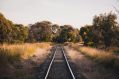 Are the state's creative industries still on track, or running off the rails? A photograph of a train track between trees at Mannerim, Victoria, Australia.