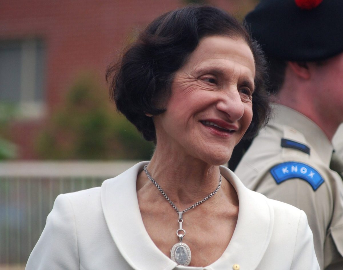 Woman with Lebanese heritage with dark hair and cream suit. Vale Dame Marie Bashir