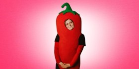 Neurospicy: The Musical at Adelaide Fringe. A fair-skinned young woman dressed in a red chili costume and smiling at the camera.