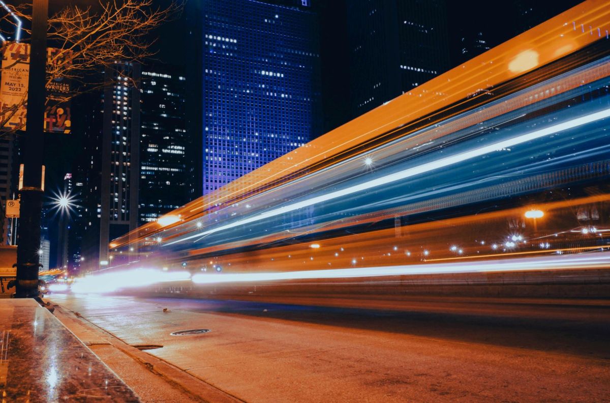 Blurred headlights and tail lights from cars and trucks passing at speed draw a series of vivid parallel lines in a long exposure photograph of a city street at night. arts sector appointments,